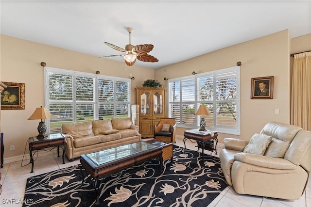 living room featuring ceiling fan, baseboards, and tile patterned floors