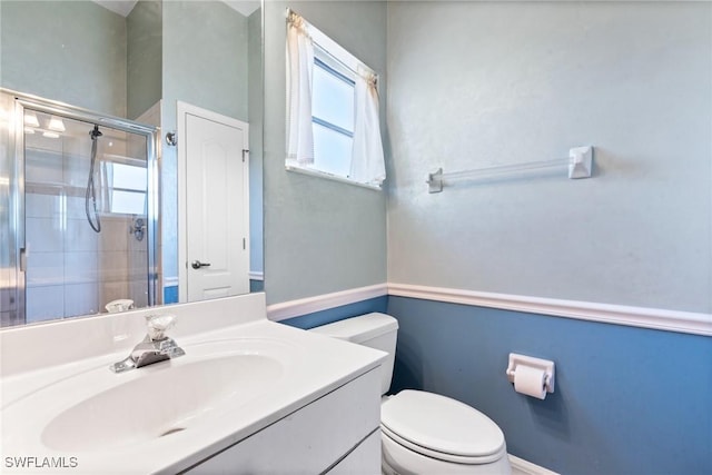 full bathroom with vanity, toilet, and a stall shower