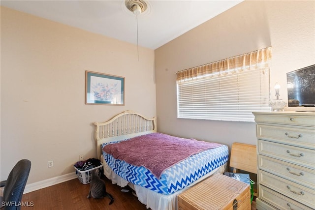 bedroom with baseboards and wood finished floors