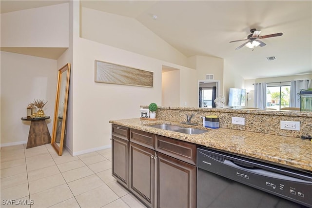 kitchen featuring light tile patterned flooring, dishwasher, a sink, light stone counters, and vaulted ceiling