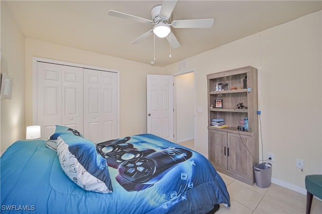 bedroom featuring a closet, a ceiling fan, light tile patterned floors, baseboards, and visible vents