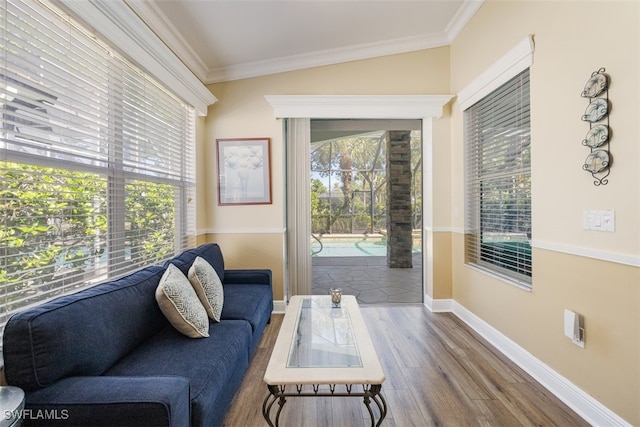 sitting room with crown molding, a healthy amount of sunlight, and wood finished floors