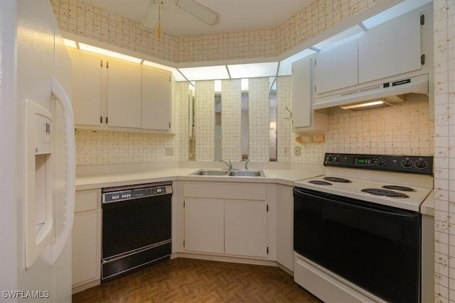 kitchen with white fridge with ice dispenser, black dishwasher, under cabinet range hood, a sink, and range with electric stovetop