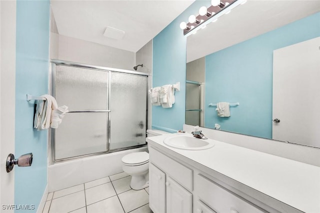 full bath with tile patterned floors, vanity, toilet, and enclosed tub / shower combo