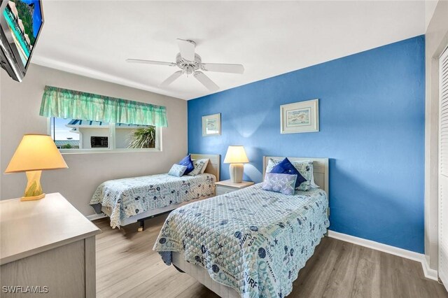 827 E Gulf Dr Unit K8, Sanibel, FL 33957 - bedroom with baseboards, ceiling fan, and wood finished floors