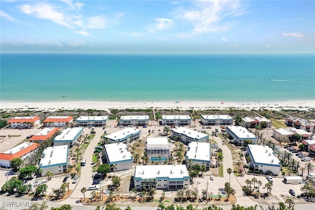 birds eye view of property featuring a water view and a view of the beach