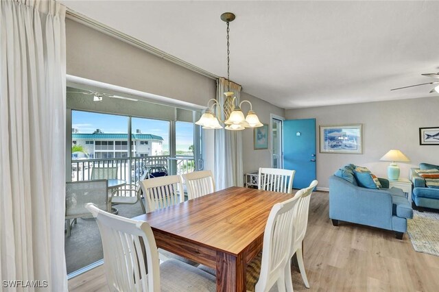 827 E Gulf Dr Unit K8, Sanibel, FL 33957 - dining space featuring light wood-style flooring and ceiling fan with notable chandelier