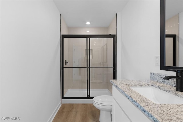 1621 NW 7th Ter, Cape Coral, FL 33993 - bathroom featuring toilet, a shower stall, wood finished floors, and vanity