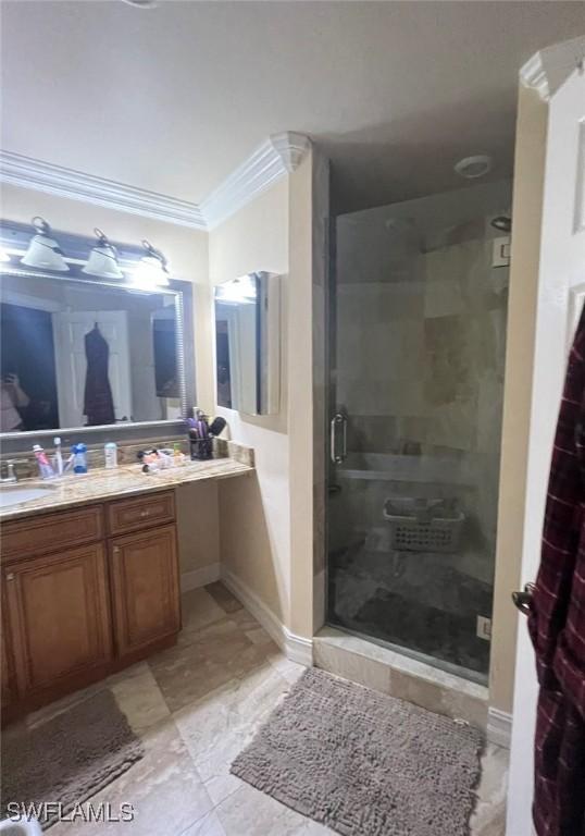 3012 10th St W, Lehigh Acres, FL 33971 - full bathroom with baseboards, ornamental molding, a stall shower, and vanity