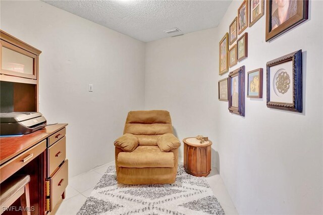 423 SE 17th St, Cape Coral, FL 33990 - sitting room with a textured ceiling, visible vents, and light tile patterned flooring