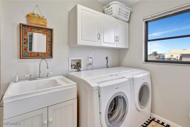423 SE 17th St, Cape Coral, FL 33990 - laundry room featuring a sink, washer and dryer, cabinet space, and baseboards