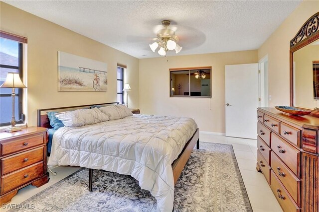 423 SE 17th St, Cape Coral, FL 33990 - bedroom with ceiling fan and a textured ceiling