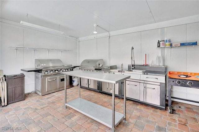 423 SE 17th St, Cape Coral, FL 33990 - kitchen featuring brick floor and a sink