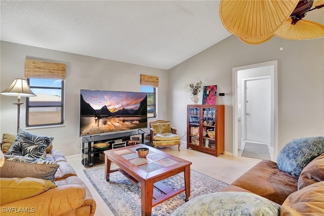 423 SE 17th St, Cape Coral, FL 33990 - living room with baseboards, vaulted ceiling, light tile patterned floors, and plenty of natural light