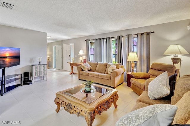 423 SE 17th St, Cape Coral, FL 33990 - living room with light tile patterned flooring, a textured ceiling, and visible vents