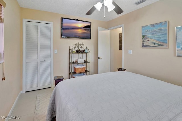 423 SE 17th St, Cape Coral, FL 33990 - bedroom featuring light tile patterned floors, a closet, baseboards, visible vents, and a ceiling fan
