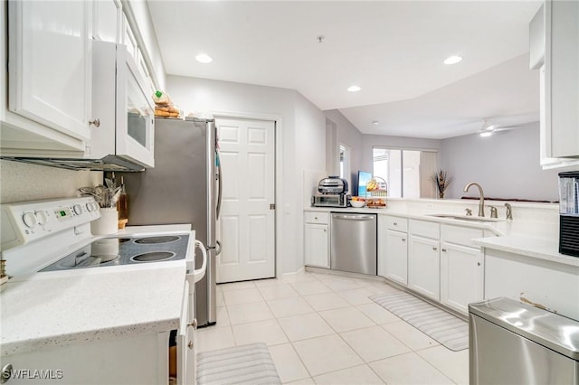 9150 Southmont Cv Unit 203, Fort Myers, FL 33908 - kitchen featuring recessed lighting, white appliances, light tile patterned floors, a sink, and white cabinets
