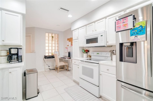 9150 Southmont Cv Unit 203, Fort Myers, FL 33908 - kitchen featuring light countertops, visible vents, white cabinets, white appliances, and light tile patterned floors