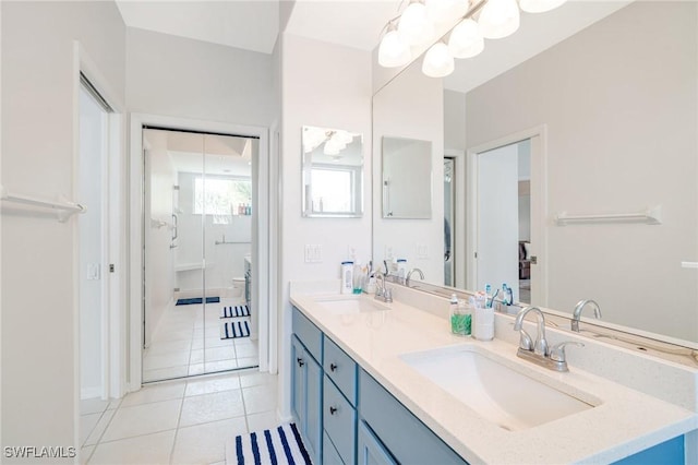 9150 Southmont Cv Unit 203, Fort Myers, FL 33908 - bathroom with baseboards, double vanity, a sink, and tile patterned flooring