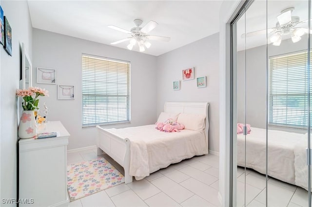 9150 Southmont Cv Unit 203, Fort Myers, FL 33908 - bedroom featuring baseboards, ceiling fan, multiple windows, and light tile patterned floors