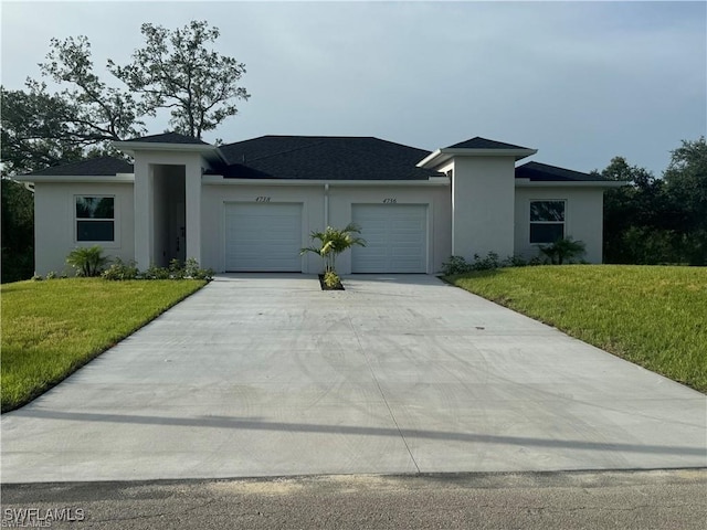 prairie-style home with stucco siding, an attached garage, a front lawn, and driveway