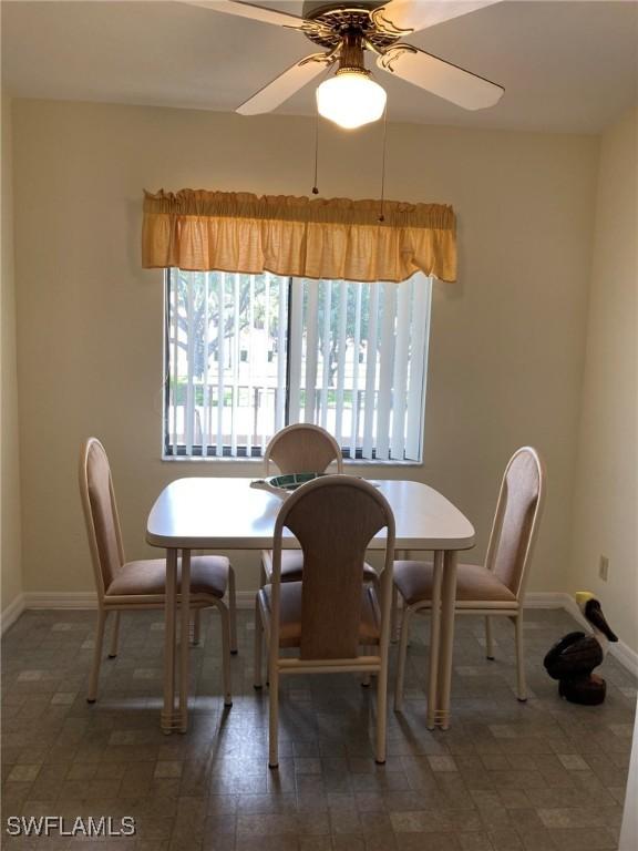 13111 Cross Creek Blvd SE Unit 215, Fort Myers, FL 33912 - dining room featuring baseboards and ceiling fan