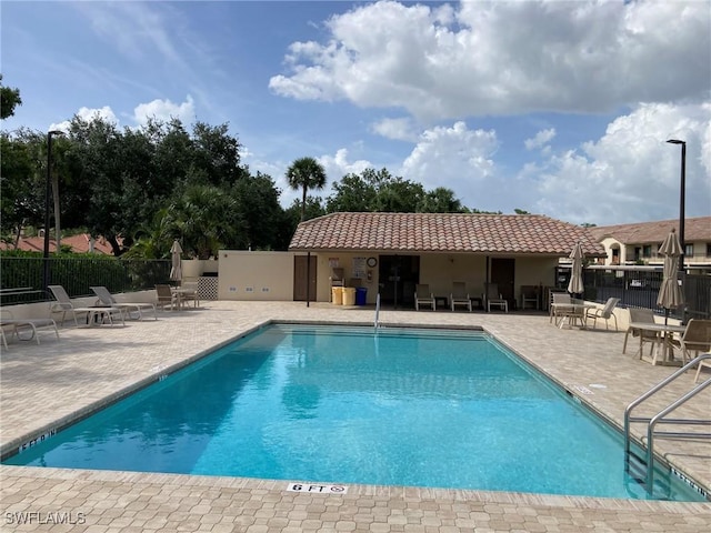 13111 Cross Creek Blvd SE Unit 215, Fort Myers, FL 33912 - community pool with a patio area