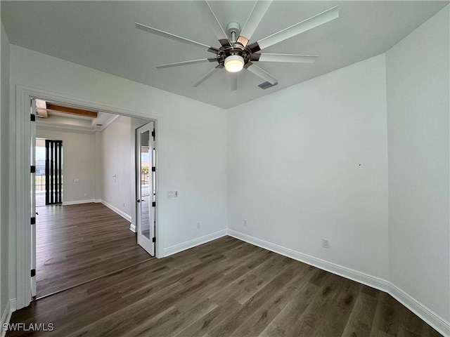 unfurnished room with visible vents, baseboards, a ceiling fan, and dark wood finished floors