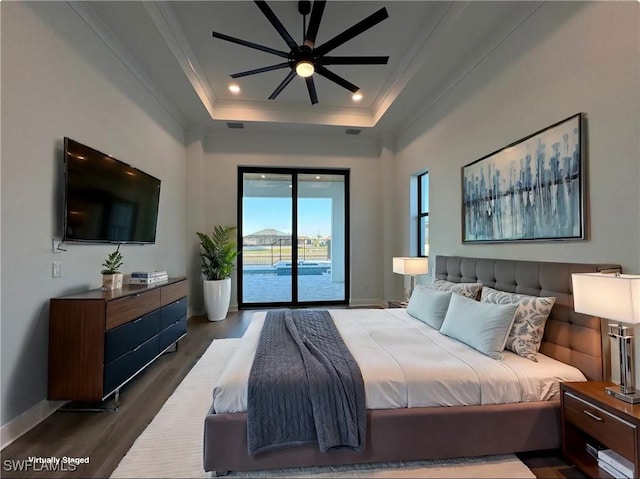 bedroom featuring crown molding, dark wood finished floors, a tray ceiling, access to exterior, and baseboards