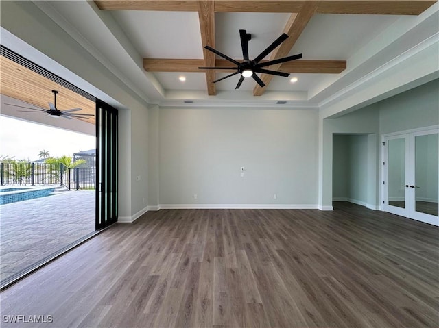 empty room featuring ceiling fan, beamed ceiling, wood finished floors, coffered ceiling, and baseboards