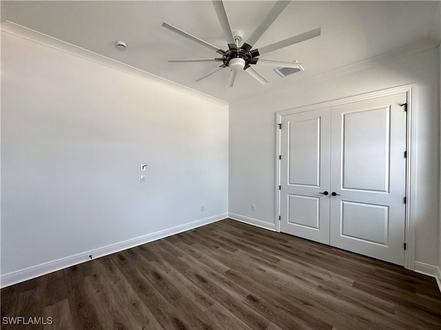 unfurnished bedroom featuring visible vents, baseboards, a closet, a ceiling fan, and dark wood-style floors