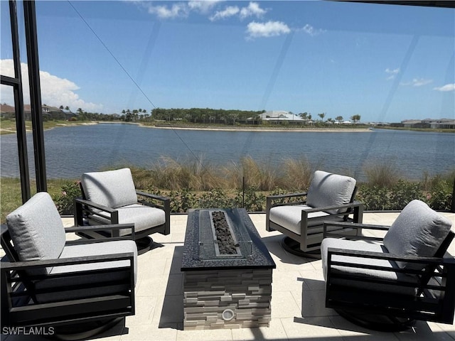 view of patio featuring a fire pit and a water view