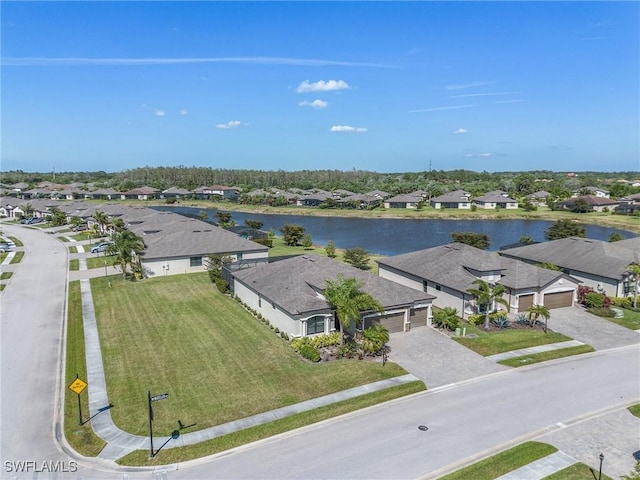 drone / aerial view featuring a residential view and a water view