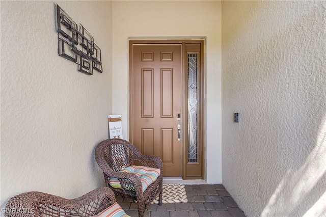 entrance to property with stucco siding
