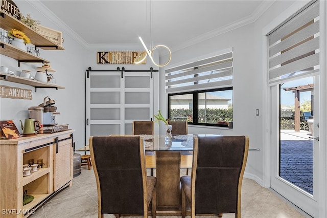 dining area featuring a barn door, ornamental molding, and light tile patterned floors