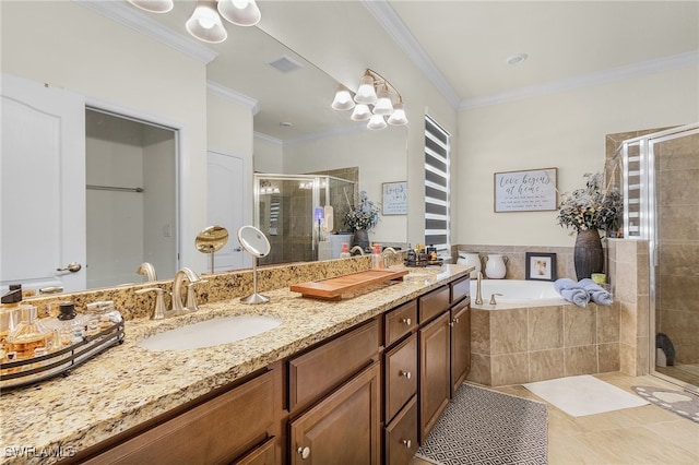 full bath with a sink, ornamental molding, a stall shower, and a garden tub