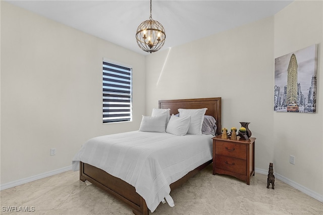 bedroom with baseboards and a chandelier