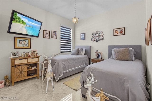 bedroom featuring marble finish floor