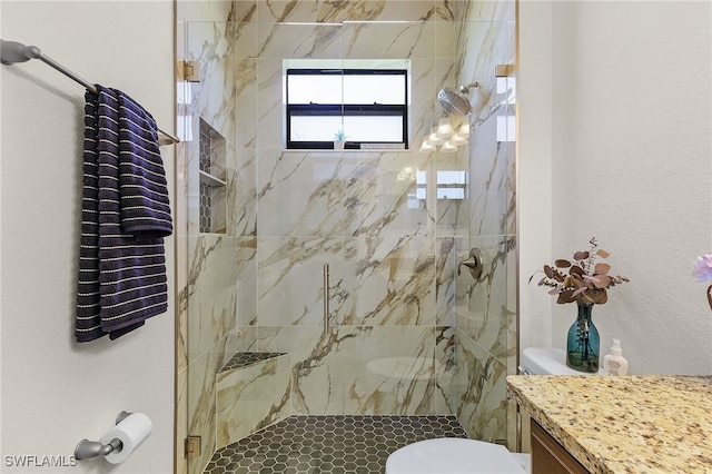 bathroom featuring toilet, vanity, and a marble finish shower