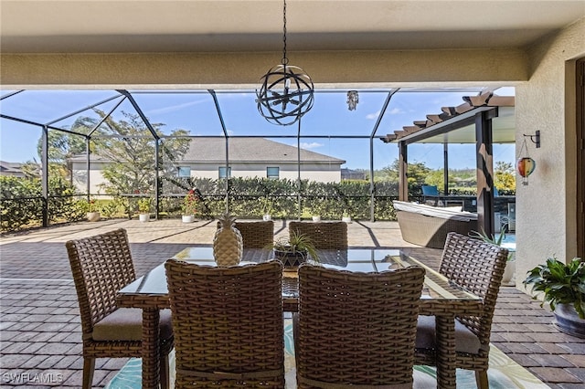 view of patio with outdoor dining area and glass enclosure