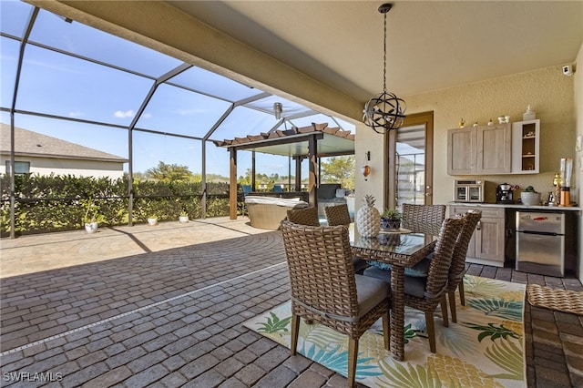 view of patio with an outdoor kitchen and a lanai