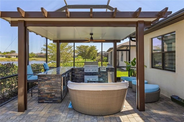 view of patio / terrace featuring outdoor dry bar, a lanai, a water view, an outdoor kitchen, and area for grilling