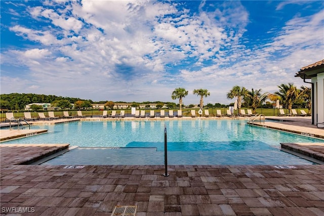 pool with fence and a patio area