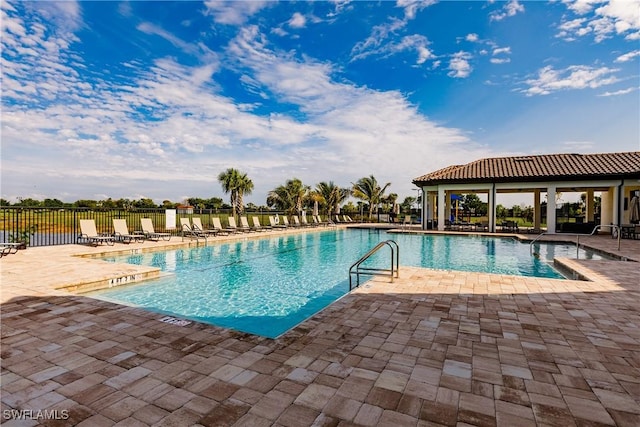 pool featuring a patio and fence