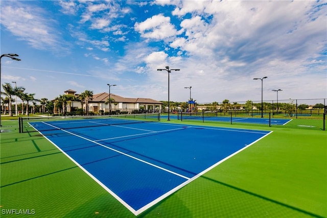 view of tennis court with fence