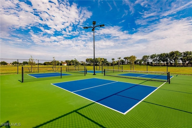 view of sport court featuring community basketball court and fence
