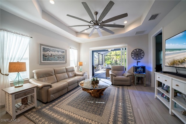 8794 Pigeon Ky, Fort Myers, FL 33908 - living room with ceiling fan, visible vents, wood finished floors, and a raised ceiling