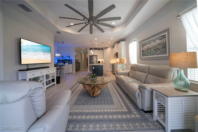 8794 Pigeon Ky, Fort Myers, FL 33908 - living room featuring light wood-style flooring, visible vents, ceiling fan, recessed lighting, and a raised ceiling
