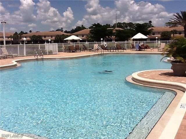 11739 Eros Rd, Lehigh Acres, FL 33971 - community pool featuring fence and a patio area
