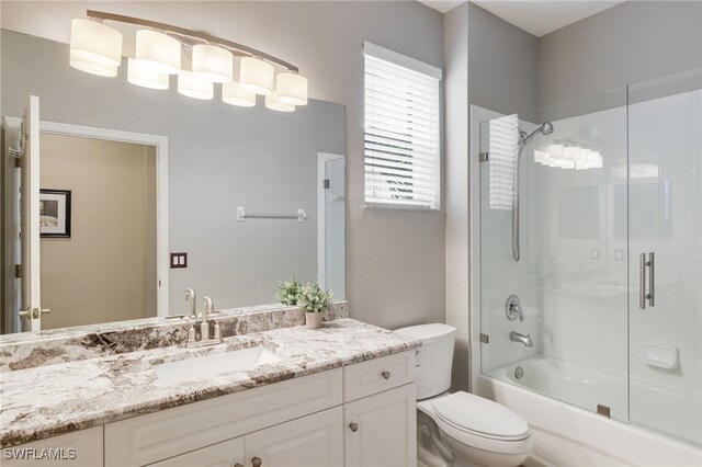 11991 Champions Green Way Unit 608, Fort Myers, FL 33913 - full bath featuring toilet, vanity, and bath / shower combo with glass door